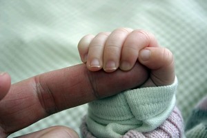 baby holding finger